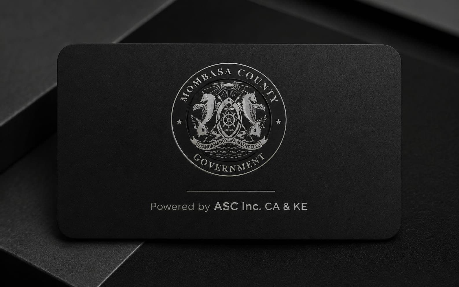 Matte black NFC card with the Mombasa County Government seal in silver, powered by ASC